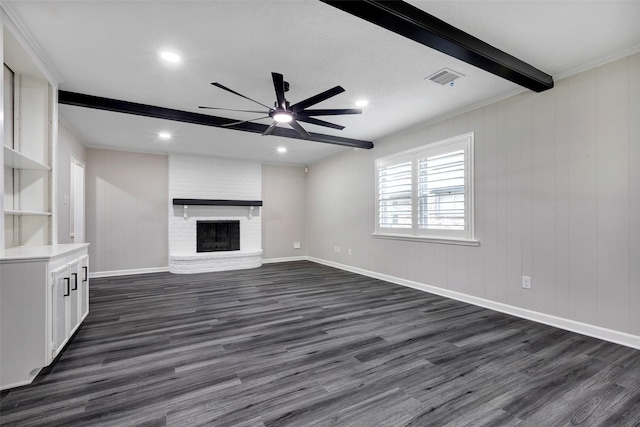 unfurnished living room featuring beam ceiling, dark wood finished floors, visible vents, ceiling fan, and a fireplace