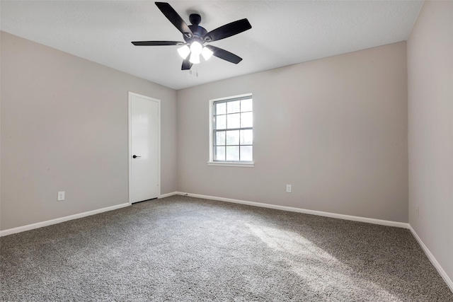 empty room featuring carpet, a ceiling fan, and baseboards