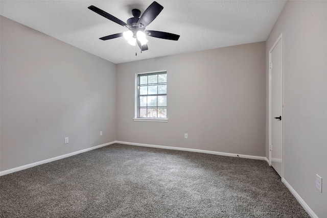 empty room featuring carpet, baseboards, and ceiling fan