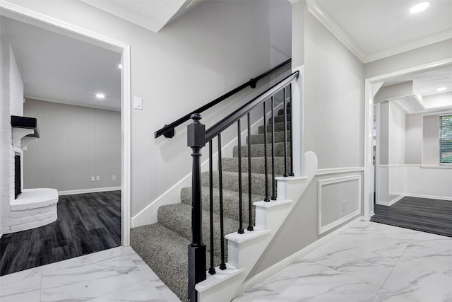 staircase with marble finish floor, baseboards, crown molding, and recessed lighting
