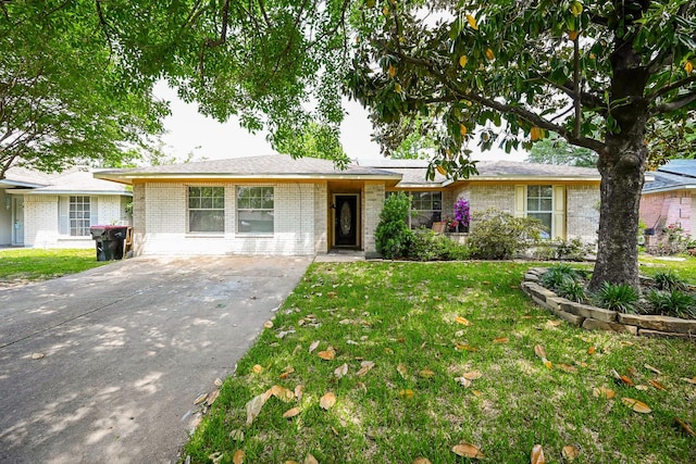 ranch-style house with brick siding, a front yard, and concrete driveway