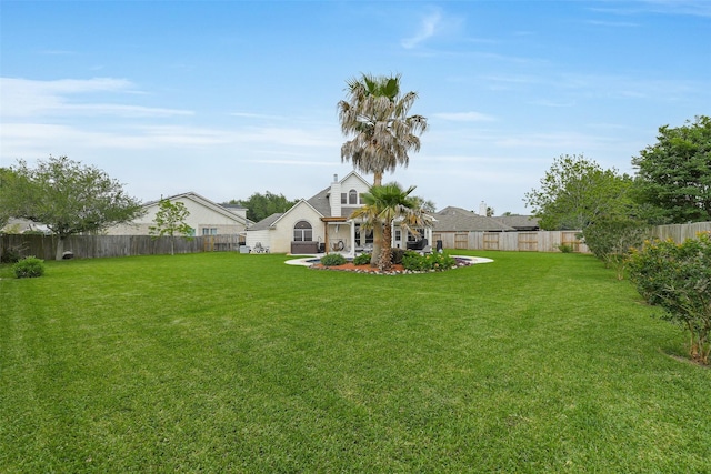 view of yard with a fenced backyard and a patio