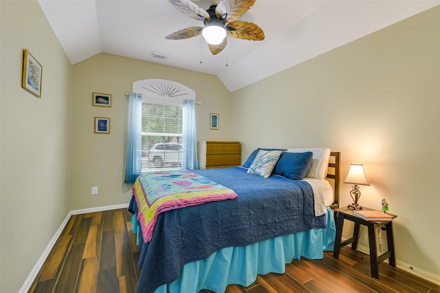 bedroom with lofted ceiling, wood finished floors, visible vents, baseboards, and ceiling fan