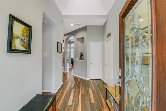 foyer entrance with arched walkways, visible vents, baseboards, recessed lighting, and wood finished floors