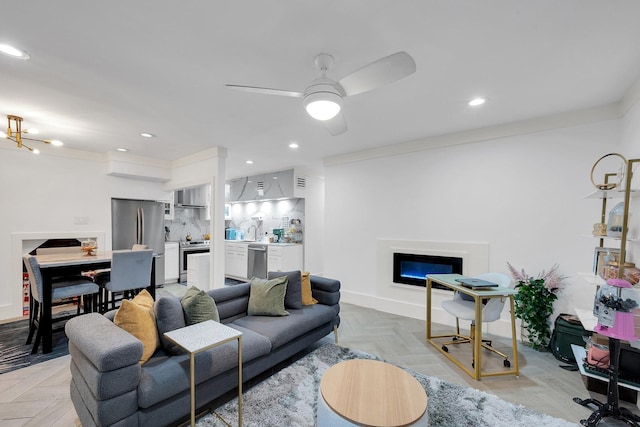 living room with recessed lighting, a glass covered fireplace, baseboards, and ceiling fan