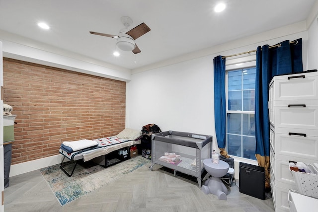 bedroom with recessed lighting, a ceiling fan, baseboards, and brick wall