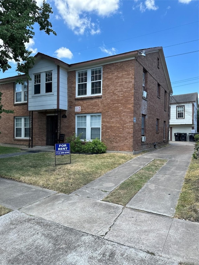 2711 Ruth St, Houston, TX 77004 - view of property with brick siding, a garage, and a front yard