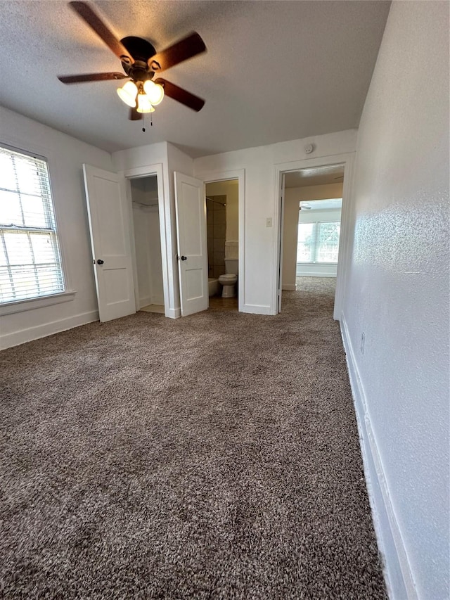 2711 Ruth St, Houston, TX 77004 - unfurnished bedroom featuring a textured ceiling, baseboards, carpet, a ceiling fan, and a closet