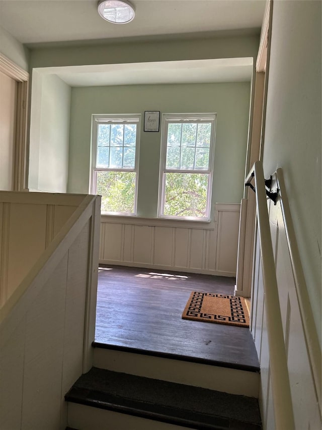 2711 Ruth St, Houston, TX 77004 - staircase with wood finished floors, a decorative wall, and wainscoting