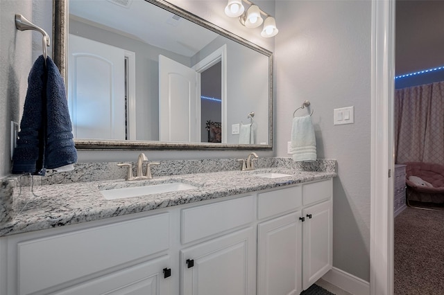 full bath with double vanity and a sink