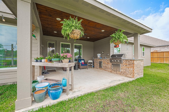 view of patio / terrace featuring area for grilling and fence