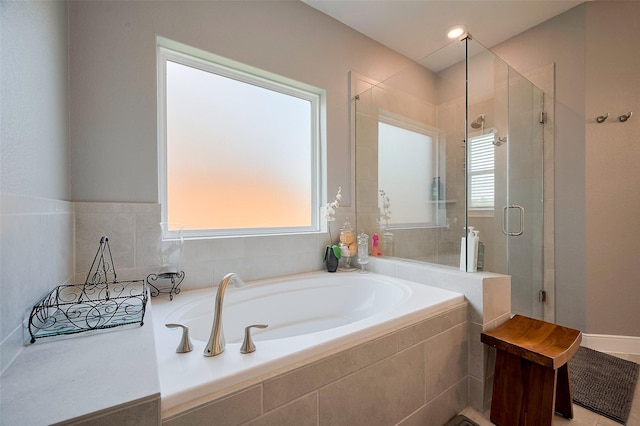 bathroom with a shower stall and a garden tub