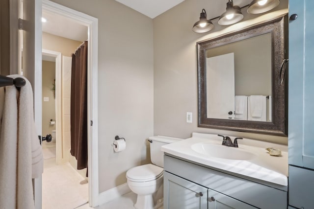 bathroom with baseboards, toilet, vanity, and a shower with curtain