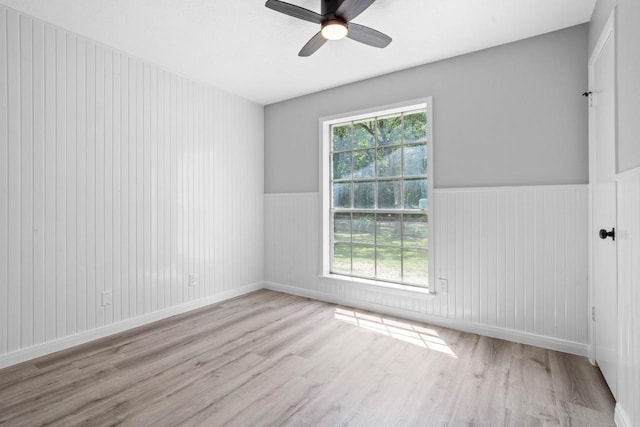 13400 Nicholson Rd, Conroe, TX 77303 - empty room featuring wood finished floors, ceiling fan, wainscoting, and wood walls