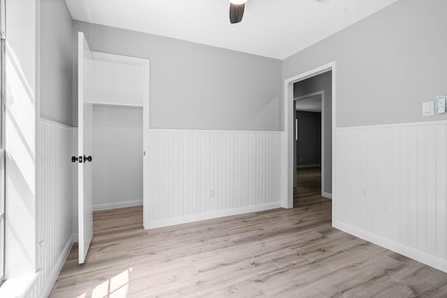 13400 Nicholson Rd, Conroe, TX 77303 - empty room featuring wainscoting, ceiling fan, and wood finished floors