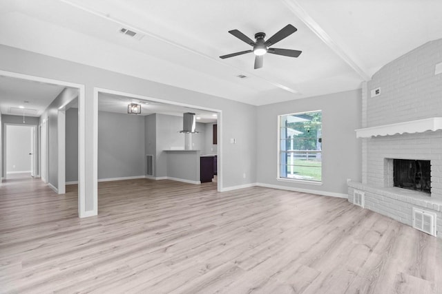 13400 Nicholson Rd, Conroe, TX 77303 - unfurnished living room featuring wood finished floors, ceiling fan, a brick fireplace, and beamed ceiling