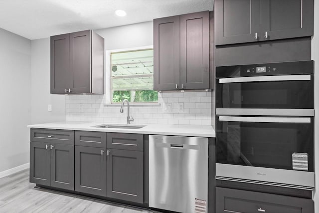 13400 Nicholson Rd, Conroe, TX 77303 - kitchen with stainless steel dishwasher, multiple ovens, light countertops, and backsplash