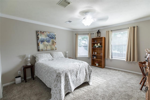 carpeted bedroom with crown molding, baseboards, and visible vents
