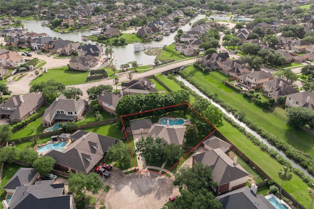 bird's eye view featuring a residential view and a water view