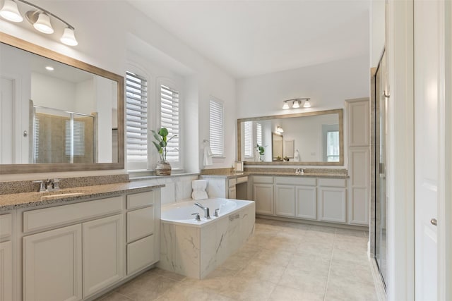 40805 Iver Ln, Magnolia, TX 77354 - full bathroom with two vanities, a shower stall, a bath, and a sink