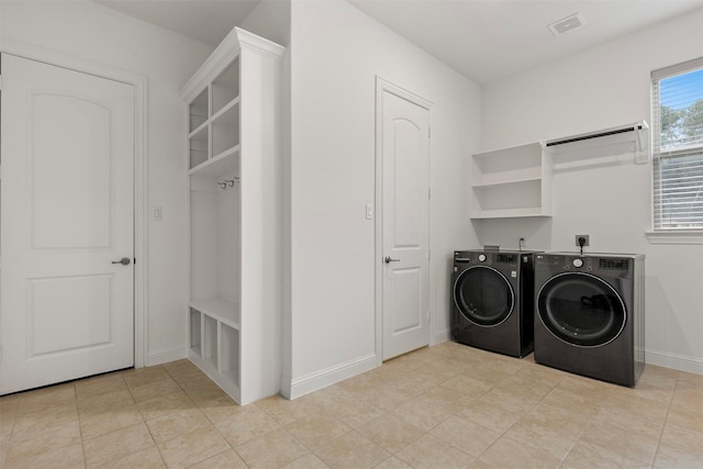 40805 Iver Ln, Magnolia, TX 77354 - washroom featuring baseboards, visible vents, separate washer and dryer, and laundry area