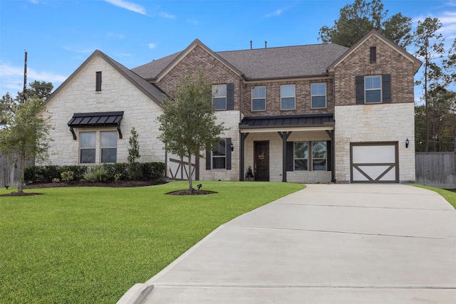 40805 Iver Ln, Magnolia, TX 77354 - view of front of house with a standing seam roof, a front lawn, a garage, driveway, and stone siding