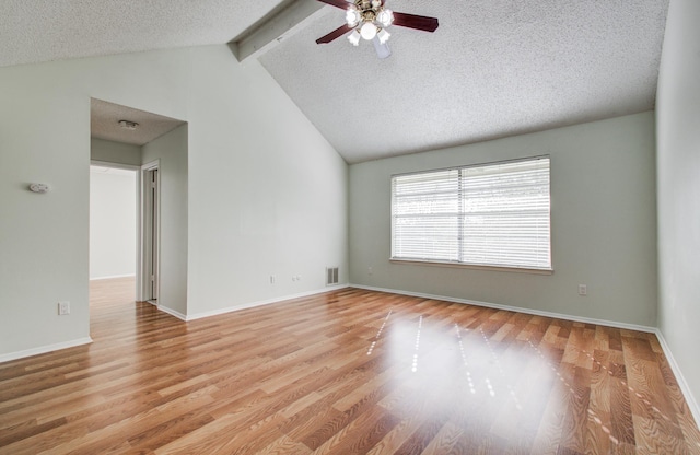 11307 Birdwing Ln, Houston, TX 77067 - spare room featuring a ceiling fan, a textured ceiling, lofted ceiling with beams, light wood finished floors, and baseboards