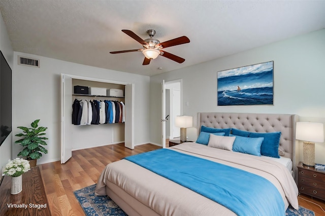 11307 Birdwing Ln, Houston, TX 77067 - bedroom with a closet, wood finished floors, visible vents, and a ceiling fan