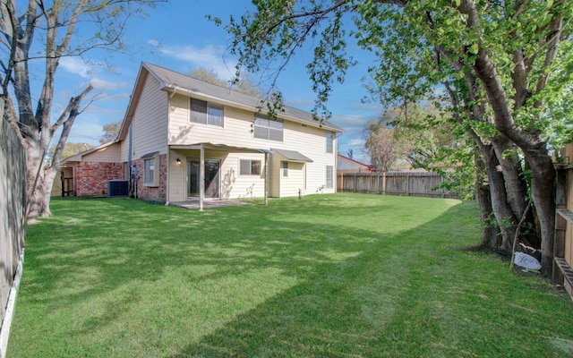11307 Birdwing Ln, Houston, TX 77067 - rear view of house featuring a lawn, a patio, a fenced backyard, and central AC unit