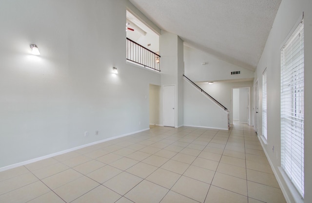 11307 Birdwing Ln, Houston, TX 77067 - empty room with a textured ceiling, baseboards, visible vents, stairs, and light tile patterned floors