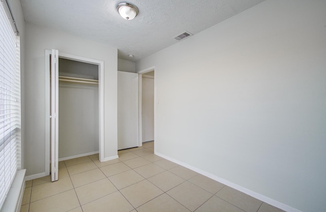 11307 Birdwing Ln, Houston, TX 77067 - unfurnished bedroom featuring a closet, visible vents, baseboards, and multiple windows