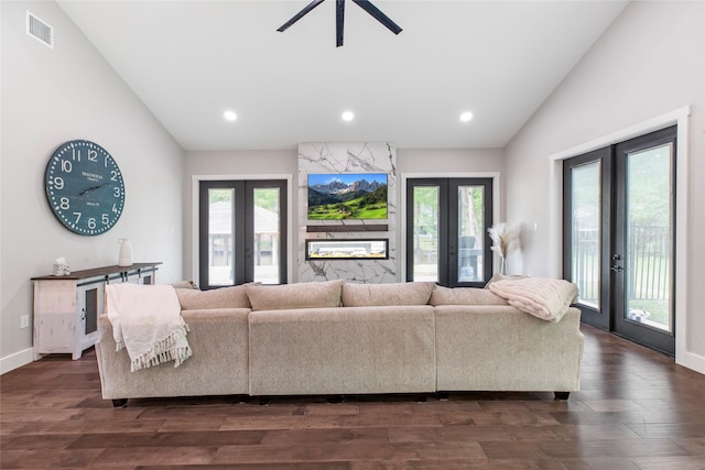 living area with french doors, visible vents, vaulted ceiling, and a healthy amount of sunlight