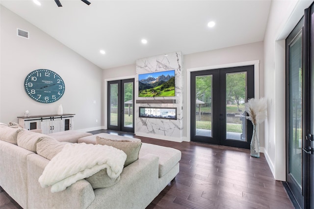 living room with recessed lighting, vaulted ceiling, a healthy amount of sunlight, and french doors