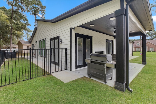 rear view of property with a yard and fence