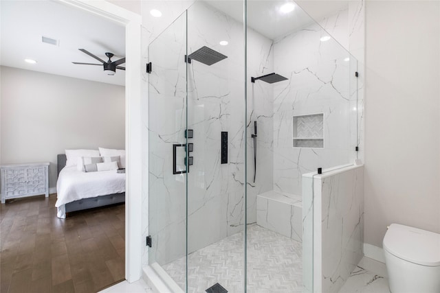ensuite bathroom with a ceiling fan, a marble finish shower, toilet, visible vents, and recessed lighting