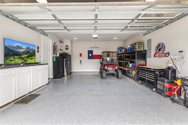 garage with a garage door opener and electric panel