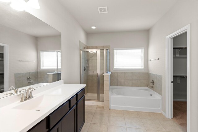 1333 Red Hills Dr, Rosharon, TX 77583 - bathroom featuring tile patterned floors, a stall shower, a spacious closet, a bath, and vanity