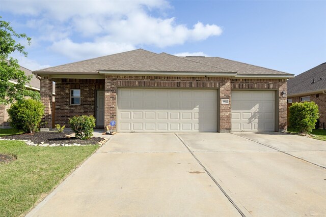 1333 Red Hills Dr, Rosharon, TX 77583 - view of front facade featuring brick siding, concrete driveway, an attached garage, and roof with shingles