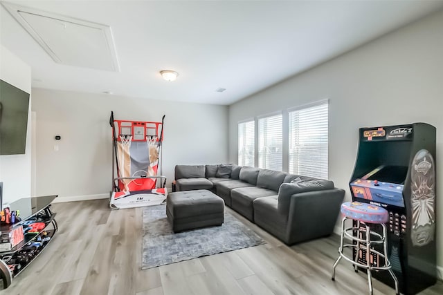 living room featuring attic access and wood finished floors