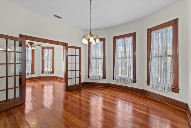 1003 Sealy St, Galveston, TX 77550 - unfurnished dining area with a chandelier, wood-type flooring, french doors, and baseboards