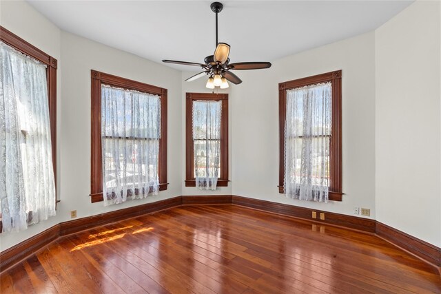 1003 Sealy St, Galveston, TX 77550 - unfurnished room featuring hardwood / wood-style flooring, plenty of natural light, ceiling fan, and baseboards