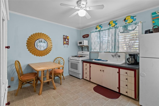 1003 Sealy St, Galveston, TX 77550 - kitchen with white appliances, crown molding, ceiling fan, dark countertops, and light floors