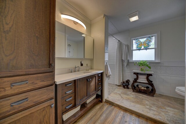 905 Clinton, Brenham, TX 77833 - bathroom with crown molding, vanity, toilet, a shower with shower curtain, and tile walls