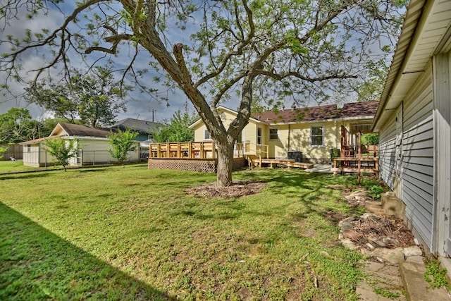 view of yard featuring fence and a wooden deck