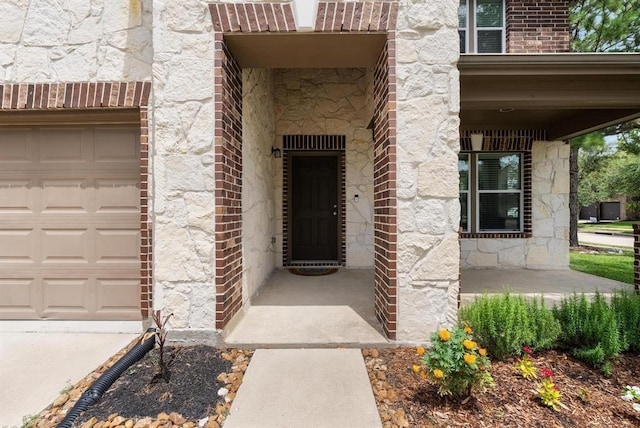 8206 Caldera Ln, Cypress, TX 77433 - entrance to property with a garage, brick siding, and stone siding