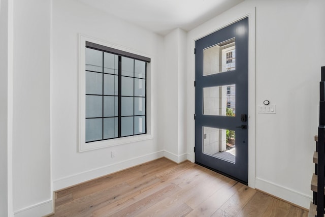 entryway featuring baseboards and wood finished floors