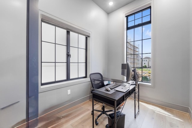 office featuring baseboards and light wood-type flooring