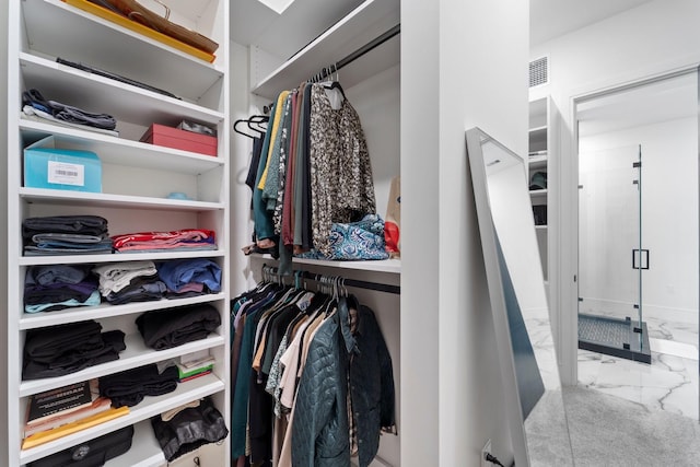 walk in closet with visible vents and marble finish floor