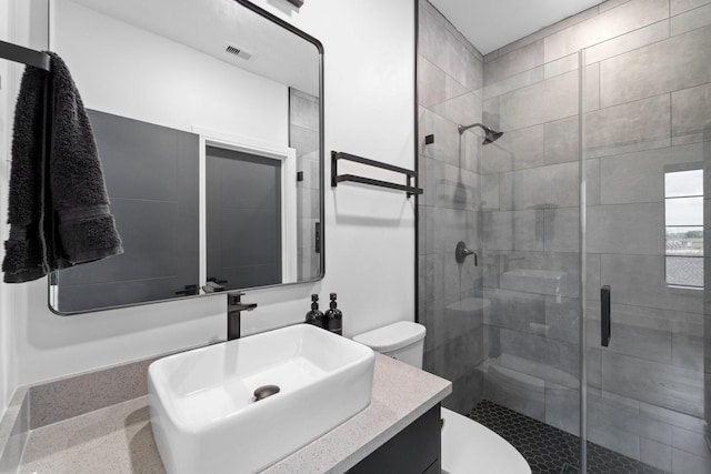 full bath with toilet, visible vents, and a stall shower