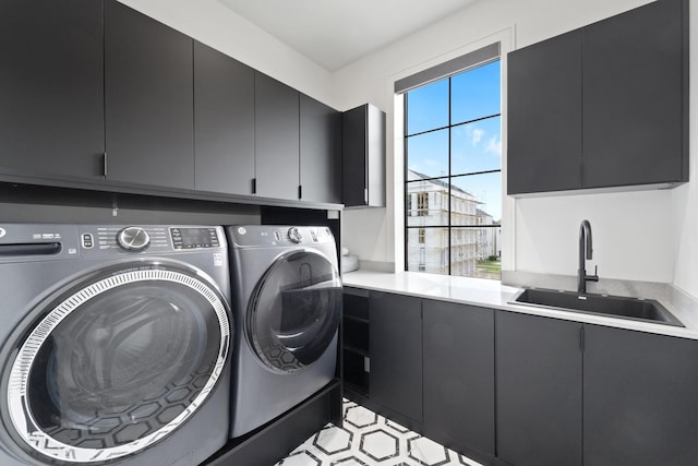 laundry area with a sink, independent washer and dryer, and cabinet space